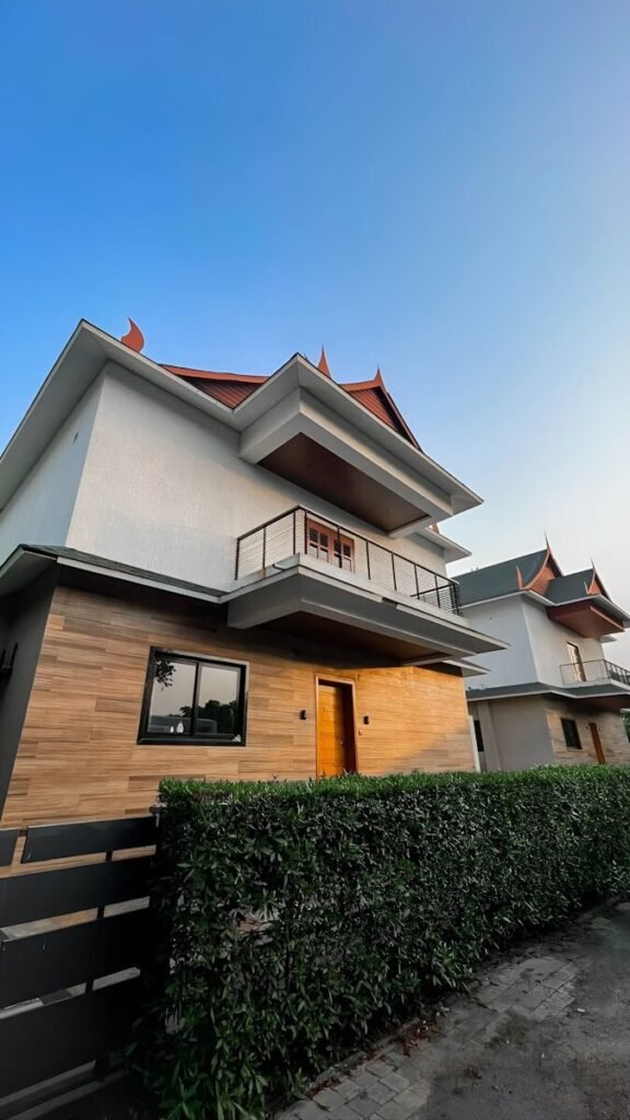 a house with a wooden fence in front of it